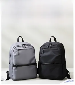 Detailed view of grey and black nylon backpacks with durable zippers and side pockets