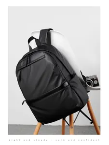 Business laptop backpack in black water-repellent fabric on a white chair background