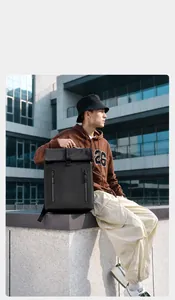 Detail of waterproof roll-top closure with buckle on black commuter backpack