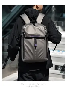 Water-resistant grey metallic backpack with purple accents shown on a city staircase