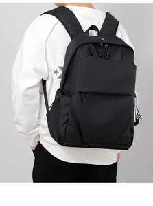 Close-up of black waterproof business backpack with side drawstring pocket on model