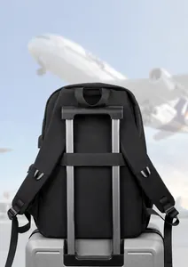 Close-up of black travel backpack with trolley sleeve strap on luggage at airport