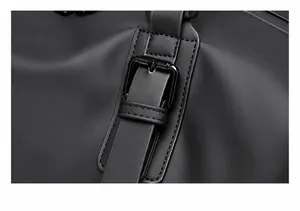 Detail of durable matte black fabric and reinforced metal buckle on a travel bag