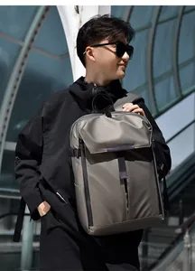 Waterproof nylon business backpack shown in urban setting with metallic gray finish
