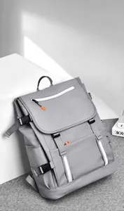 Detail of grey waterproof laptop backpack featuring safety reflective strips and buckles