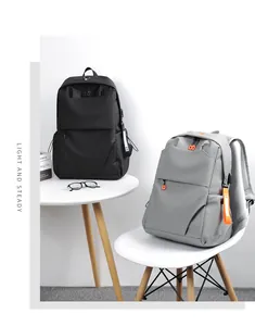 Detail view of black and grey travel backpacks featuring waterproof matte fabric and pockets