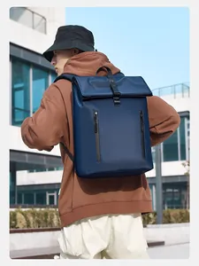 Detail of navy blue roll-top backpack with water-resistant fabric and dual vertical zippers