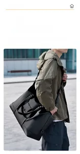 Close-up of waterproof black travel bag with adjustable strap and durable hand grips
