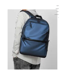 Detail of a navy blue business backpack with metallic luster and padded shoulder straps