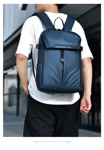Navy blue travel backpack with water-resistant fabric shown on model in urban setting