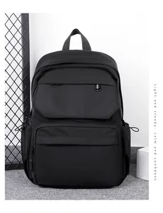 Detail of waterproof black travel backpack with multi-compartment design and drawstring side pocket