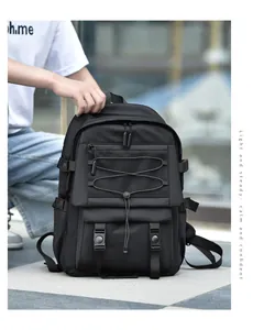 Detail of waterproof black backpack with X-shape elastic cords and mesh zipper pocket