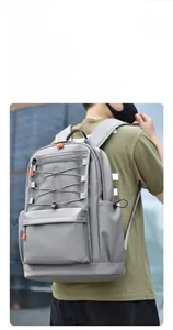 Detailed side view of lightweight charcoal grey casual backpack with orange accents