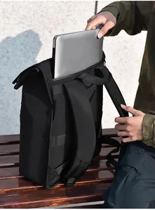 Detail of a black business backpack on a bench featuring a dedicated laptop compartment
