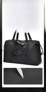 Detail showing waterproof and scratch-resistant fabric of the black travel duffel bag