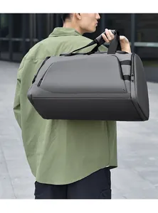 Gray waterproof sports gym bag shown on shoulder in an outdoor urban setting