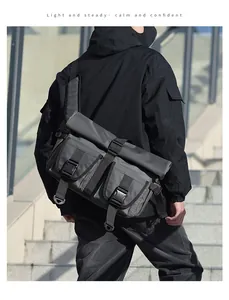 Detail of waterproof dark grey messenger bag with buckle closures and urban utility design