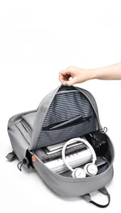 Detailed interior of gray backpack with striped lining and multiple storage compartments