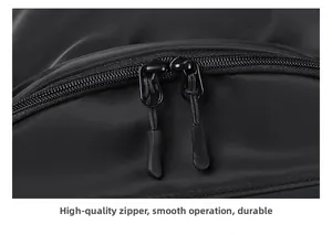 Close-up of smooth dual metal zippers and durable nylon fabric on a black backpack