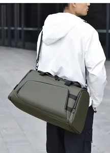 Side view of olive green large capacity travel bag worn by a model in outdoor setting