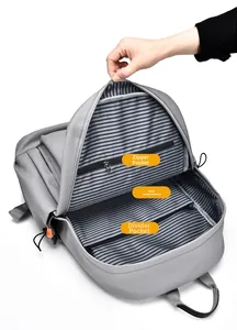 Detail of grey backpack interior showing zipper pocket and laptop compartment