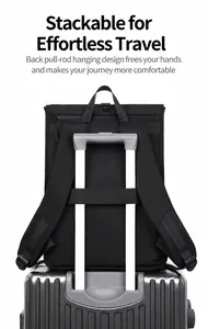 Detail showing the practical luggage strap on back of the black business travel backpack