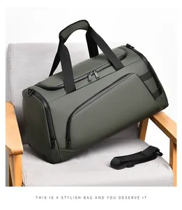 Detailed view of an olive green travel bag with water-resistant fabric on a grey chair