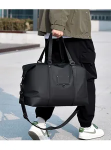 Detail of waterproof matte black travel bag with adjustable strap and metal buckles