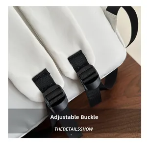 Detailed close-up of white backpack featuring a sturdy black adjustable strap buckle