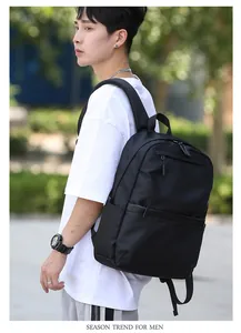 Detailed view of black multi-compartment business laptop backpack on male model