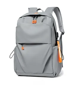 Detail view of water-resistant gray backpack showing contrast orange zipper pulls