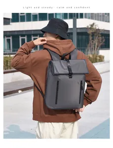 Close-up of matte dark grey business backpack with fold-over top and buckle detail