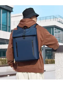Waterproof navy blue business backpack with flap top and leather buckles on male model
