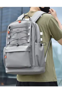 Detail of grey waterproof laptop backpack with orange zipper pulls and side mesh pockets