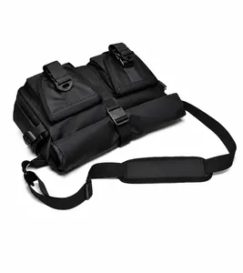 Top view of black waterproof messenger bag with dual buckled pockets and padded strap
