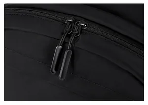 Macro shot of durable dual zippers on a waterproof black fabric outdoor backpack
