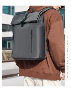Detail of dark grey waterproof roll-top backpack with dual vertical zipper pockets