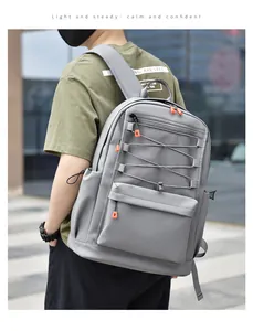 Detail of grey student backpack featuring orange zippers and functional mesh pocket