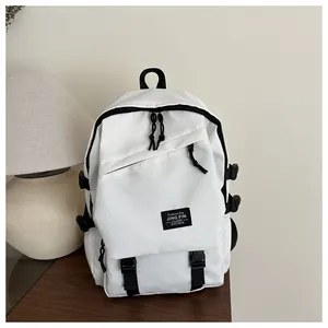 Close-up of durable white nylon backpack with black zipper and branded fabric label