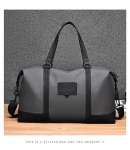 Front view of travel bag with gray matte fabric, dual handles and adjustable shoulder strap
