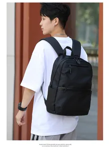 Rear view of a black business backpack showing wide shoulder straps and side pockets