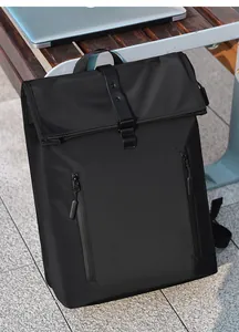 Outdoor view of waterproof black roll-top backpack with dual vertical zipper pockets