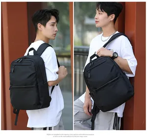 Detail view of black high-density nylon backpack with side pockets and smooth zippers