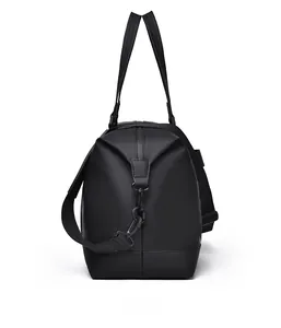 Side view of black water-resistant gym bag with dual handles and detachable strap