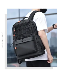 Detail of black nylon backpack featuring orange zipper accents and mesh pocket compartment