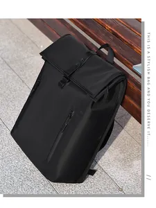 Outdoor shot of a black minimalist roll-top backpack with a leather buckle and side zipper