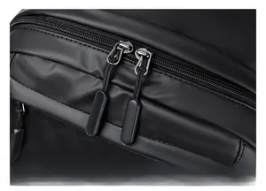 Detail view of double zippers and matte waterproof fabric on this business backpack