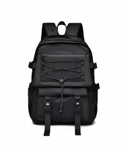 Front detail of black tactical backpack with mesh zipper pocket and elastic bungee cords