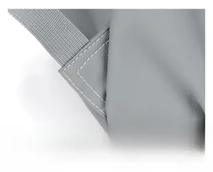 Macro detail of triangle reinforcement stitching on grey durable fabric backpack