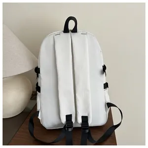 Rear view of white minimalist backpack with black straps and adjustable buckles